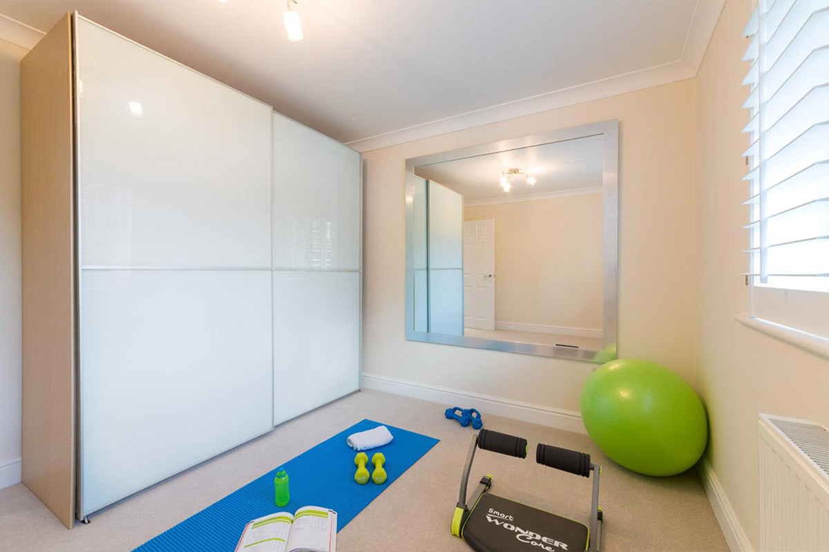 Home exercise room with a yoga mat, weights and a fitness ball